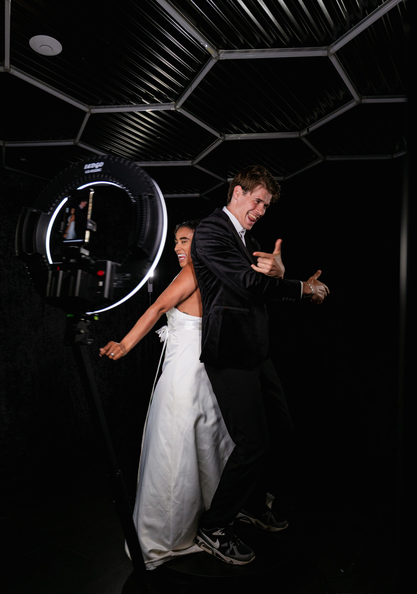 Bride and groom dancing at a ring light photo booth