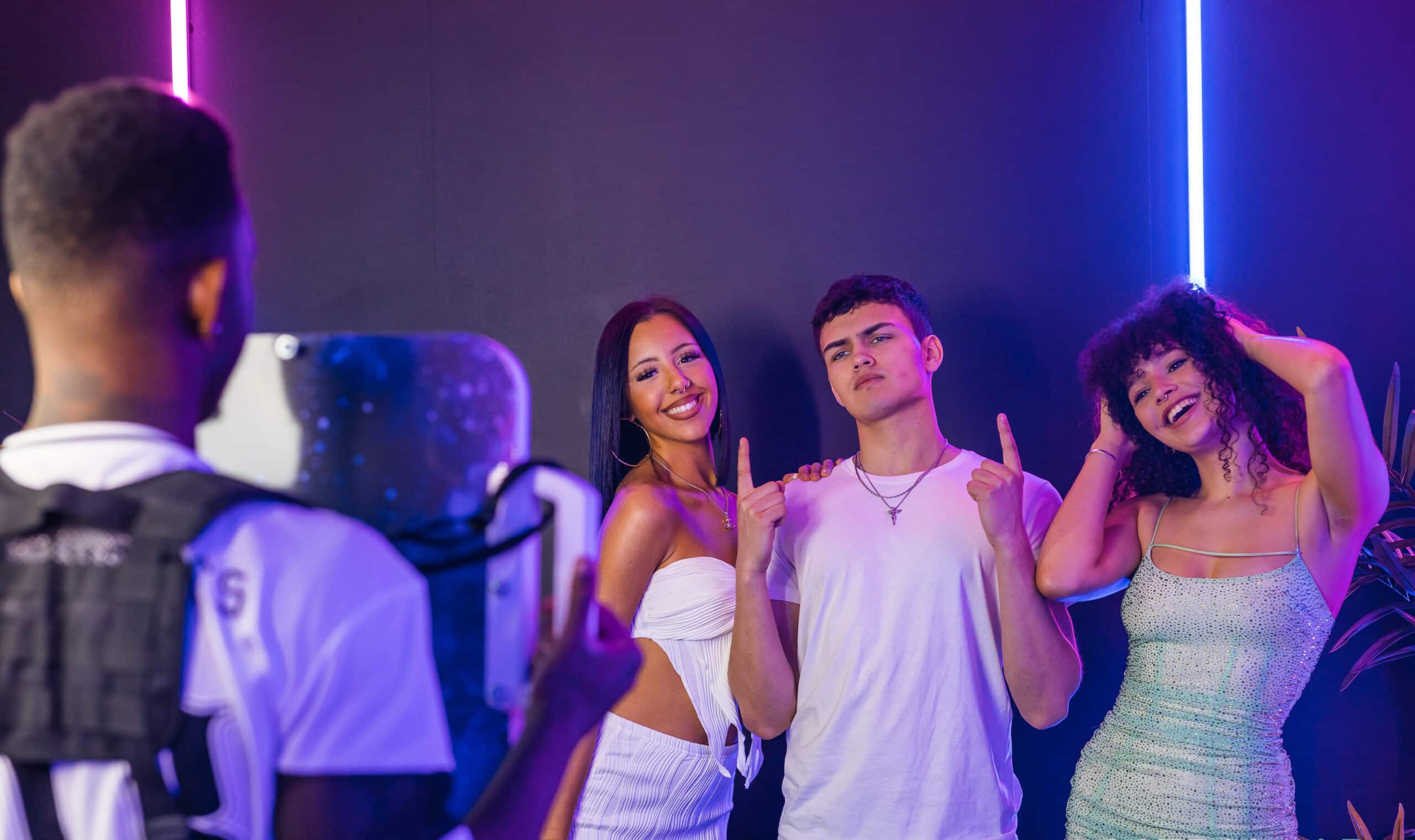 Couple posing together under blue party lighting