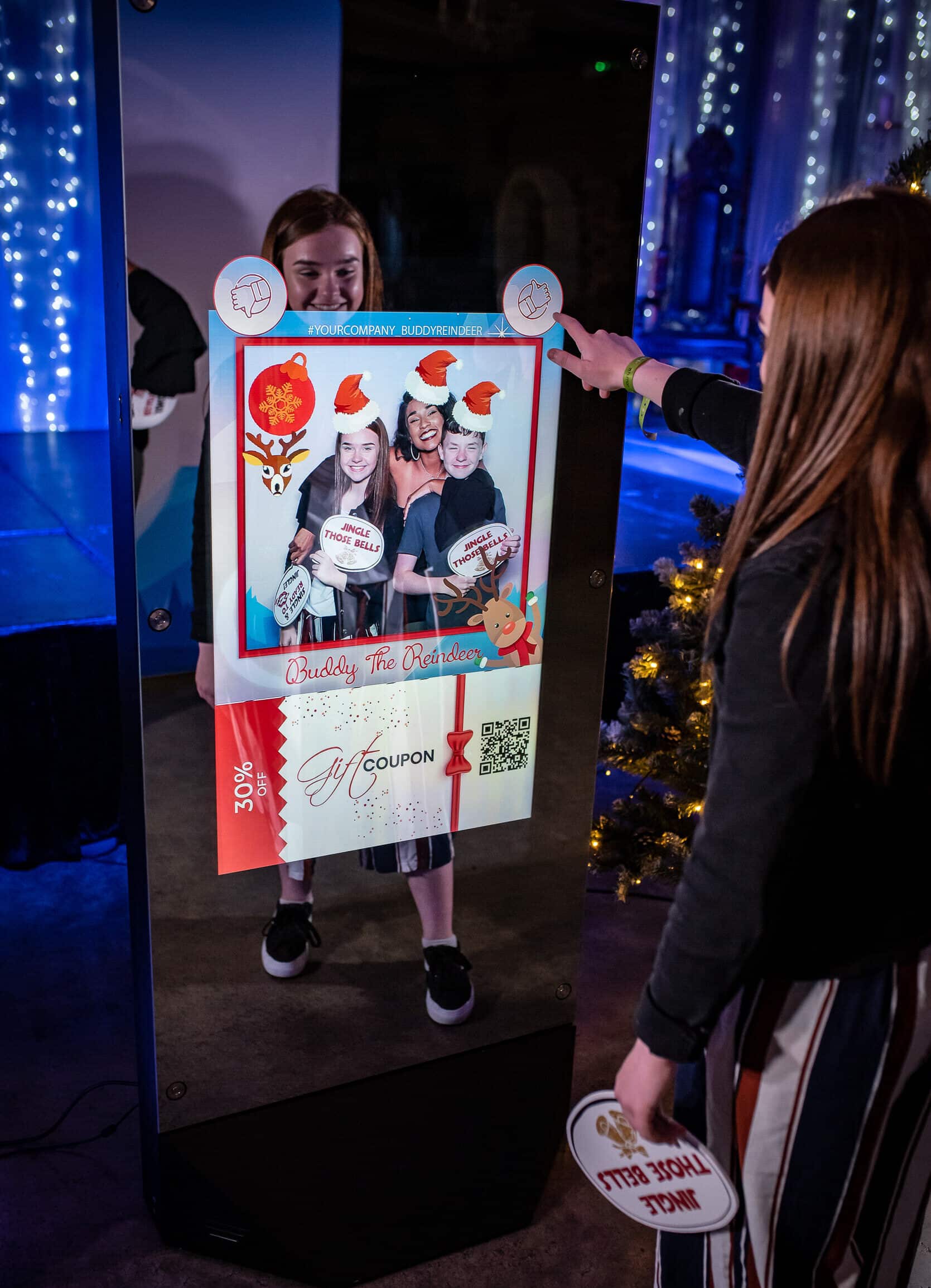 Guest at a photo booth screen showing holiday-themed photo prints