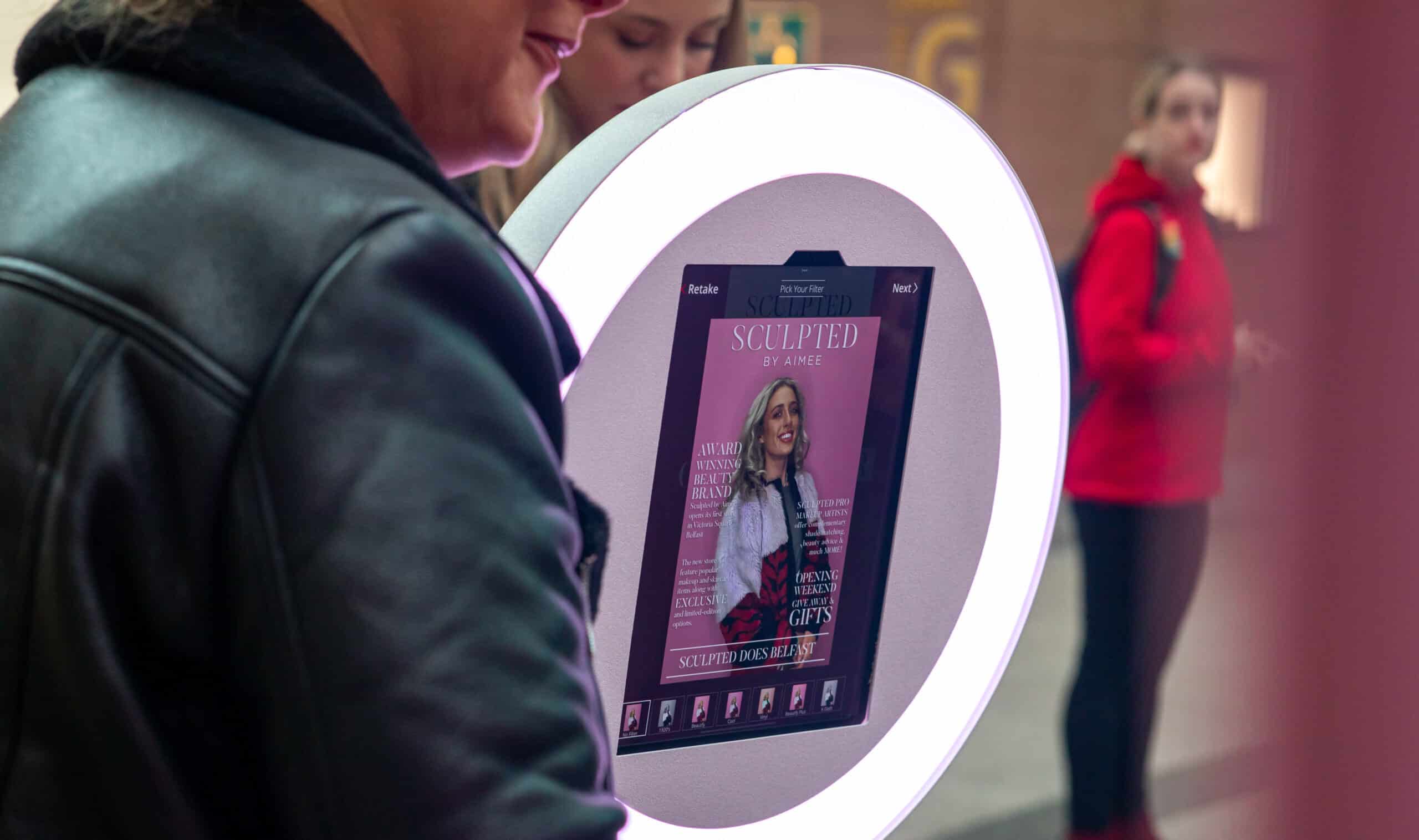 Guest using a ring light photo booth at an event