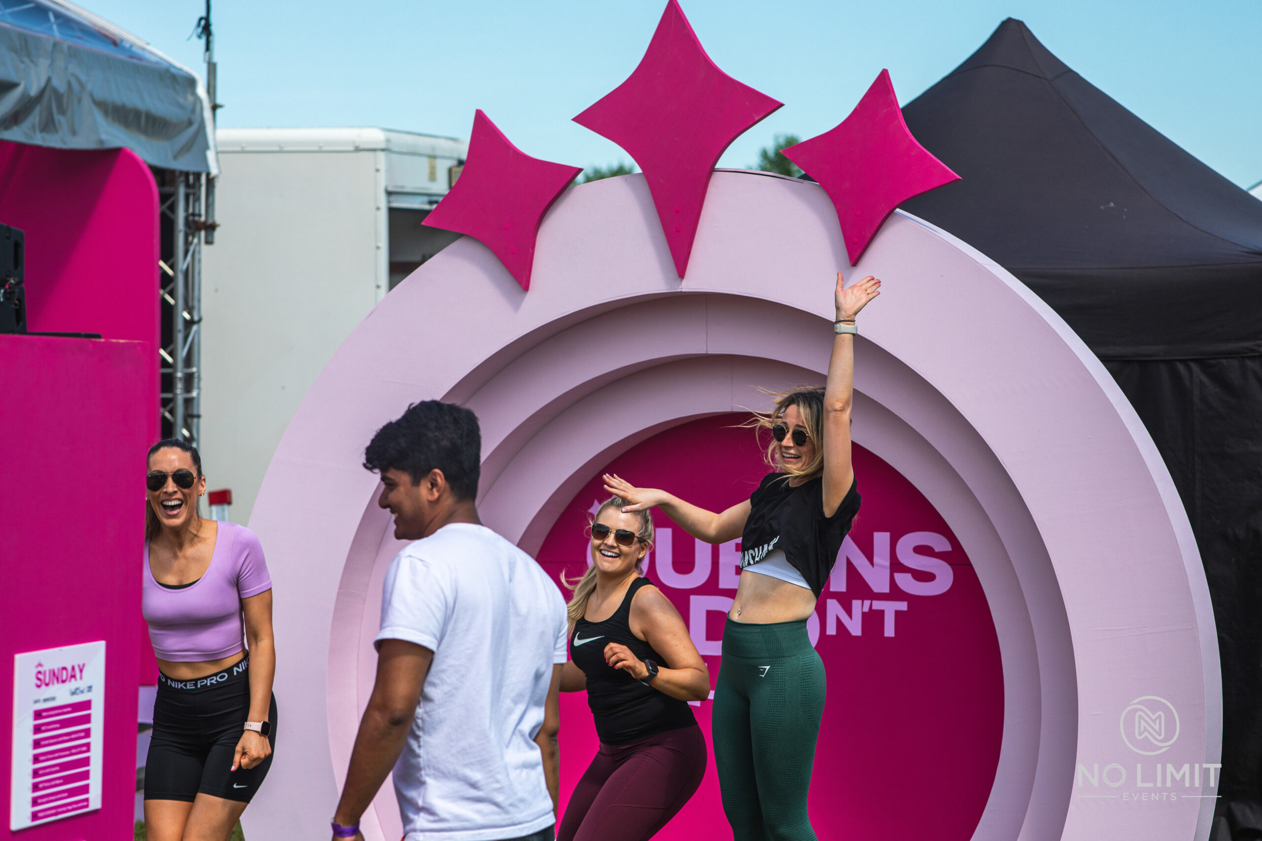 Black attendant at a corporate outdoor event with females