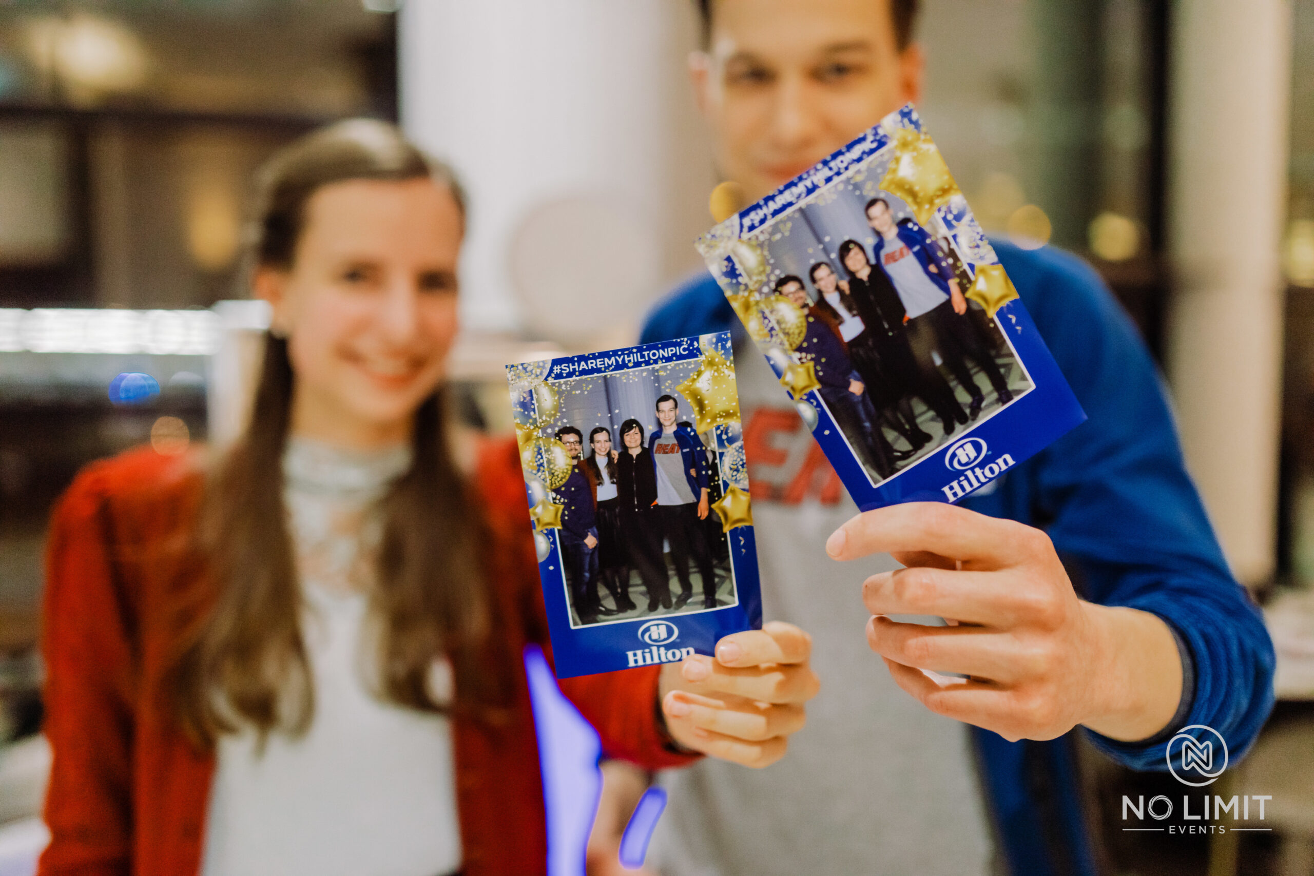 visitors at an event showing copies of photos they had taken