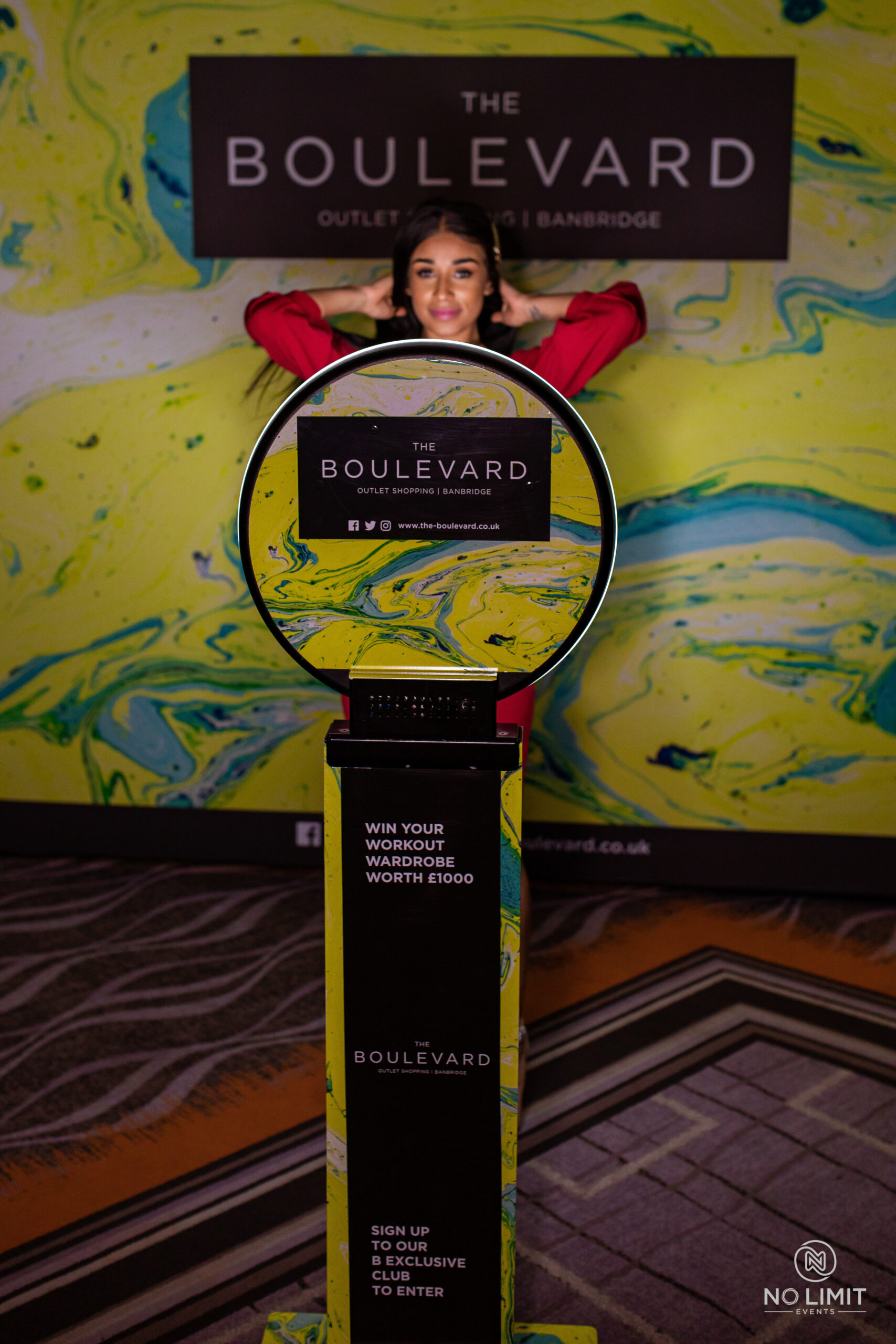Ring light photo booth in front of a colorful abstract mural wall