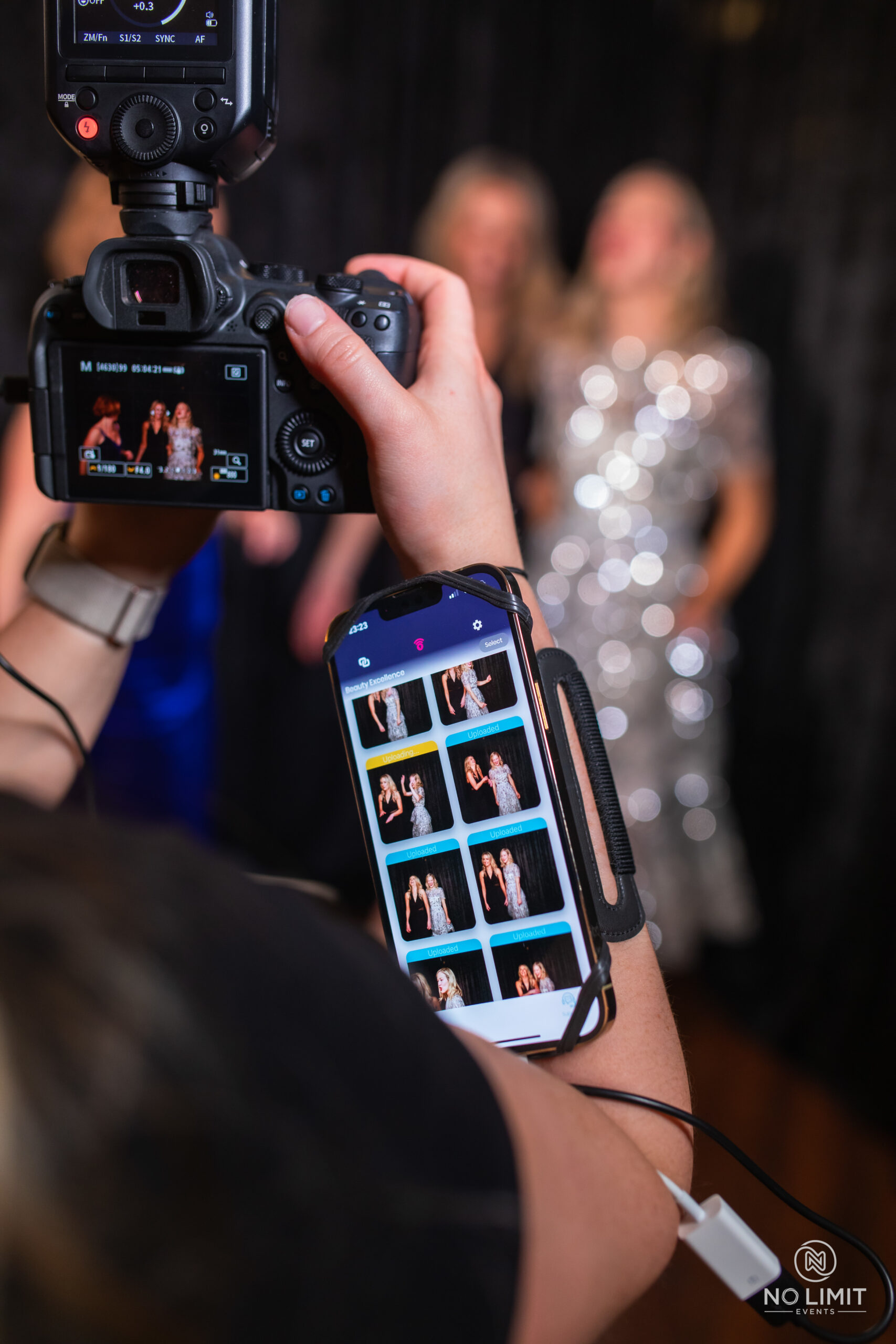 Camera and phone displaying photo booth pictures from an event