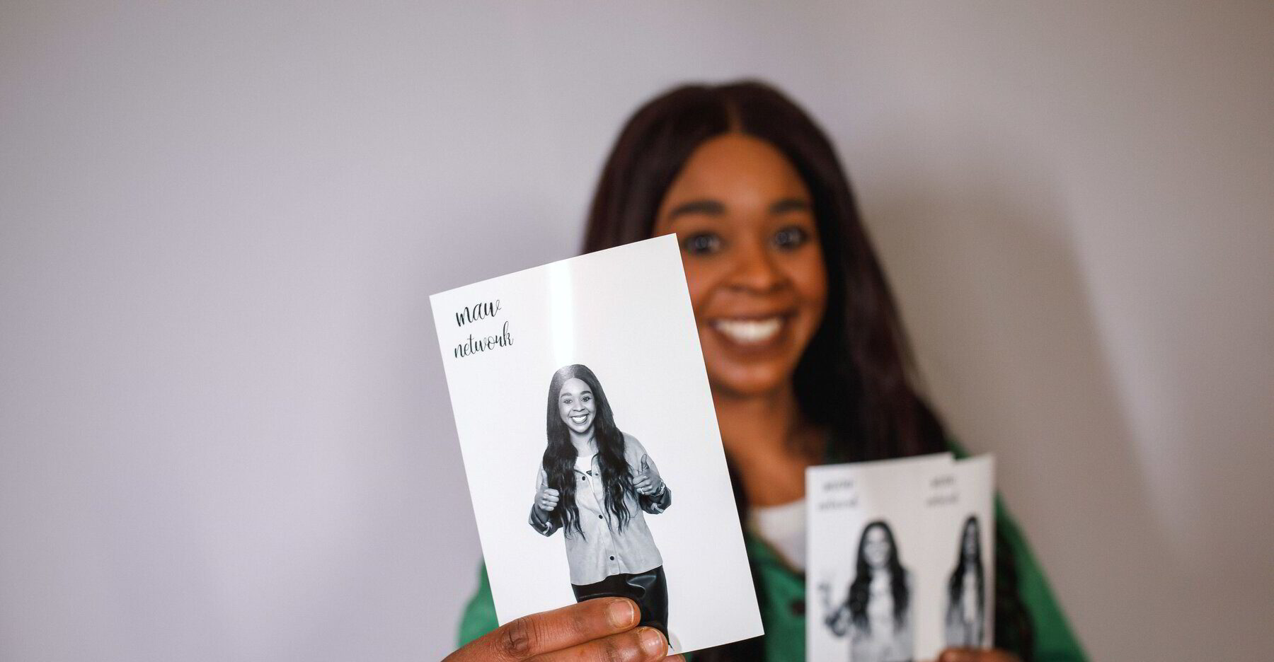 Smiling woman holding up her black-and-white photo booth print